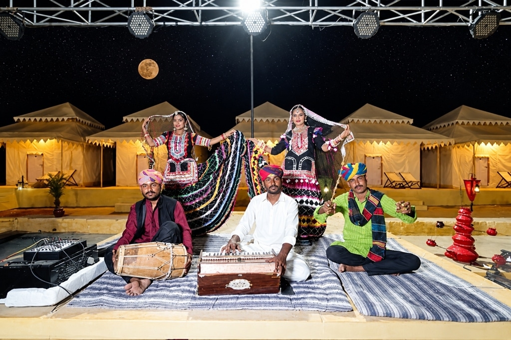 Live Rajasthani Manganiyar folk musicians playing harmonium and dholak under the moonlight